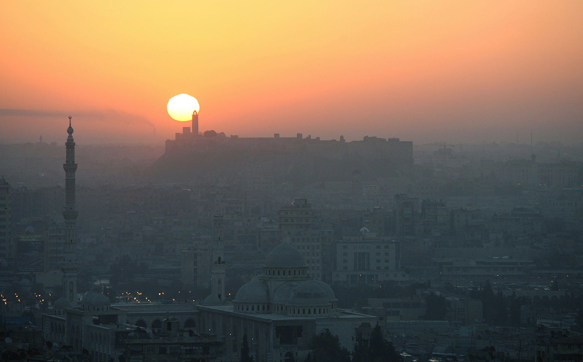 General view of Aleppo in Syria during sunrise March 7, 2006. Aleppo was chosen by the Islamic conference organization in 2004, to become the capital of Arab-Islamic culture on March 18, 2006, after Makkah in 2005. Aleppo, along with Damascus and Sana'a, are the three oldest inhabited cities in human history, and was added to UNESCO's World Heritage List in 1986.   REUTERS/ Khaled al-Hariri - RTR1778G