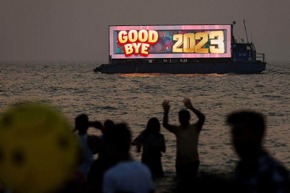 People watch the last sunset of the year from a beach on New Year's eve in Mumbai, India. REUTERS/Francis Mascarenhas