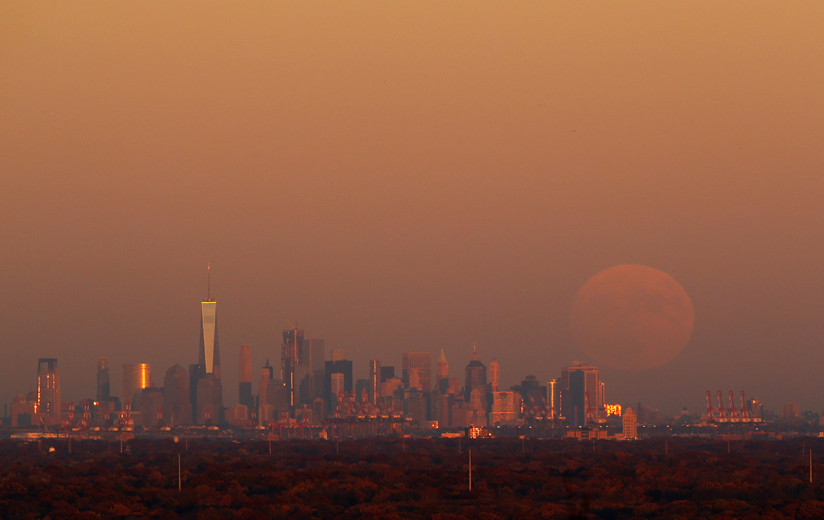 WATCHUNG, NJ - NOVEMBER 13: A super moon rises at sunset over lower Manhattan in New York City on November 13, 2016 as seen from Watchung, NJ. (Photo by Gary Hershorn/Getty Images)